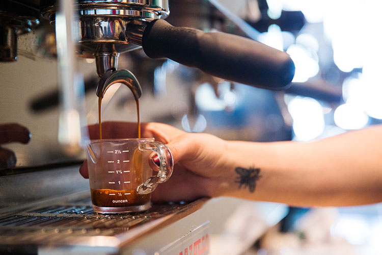 Server making an espresso